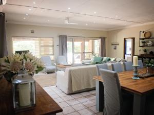 a living room with a couch and a table at Galago Way in St Lucia