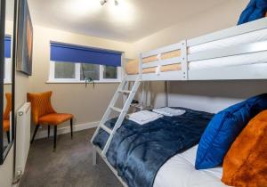 a bedroom with a bunk bed and a ladder at Station Lodge By My Getaways in Brighton & Hove