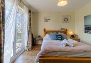 a bedroom with a bed and a large window at Sussex Retreat with Free Parking for 4 Vehicles - By My Getaways in Pyecombe