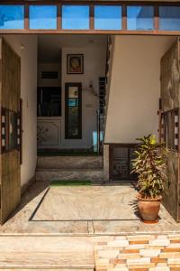 - une vue depuis l'intérieur d'une maison avec une plante en pot dans l'établissement Cocoon Auberge, à Jaipur