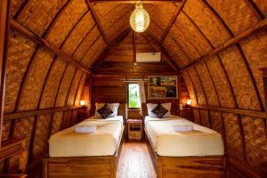 En eller flere senger på et rom på Kubu Sental Cottage