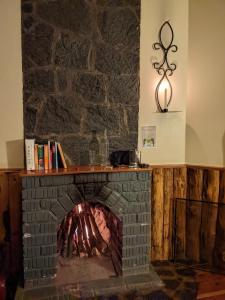 a brick fireplace with a mantle on top of it at Lawns Hotel in Lushoto