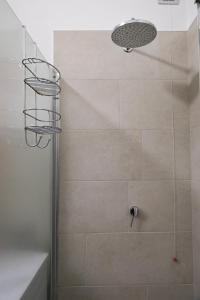 a shower with a shower head in a bathroom at Appartamento Prada in Endine Gaiano