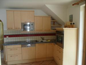 a kitchen with a sink and a microwave at Ferienhaus 2 in Auberg