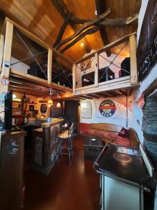a room with a kitchen and a bar in a trailer at La Vieille Forge B&B in Houffalize