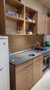 a kitchen with wooden cabinets and a counter top at Apartments in Ramada 2 Complex in Bansko