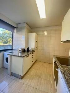 a kitchen with a sink and a counter top at Jardim do Carregal in Porto