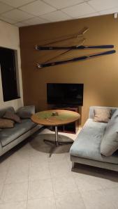 a living room with a table and a couch at Apartments in Ramada 2 Complex in Bansko