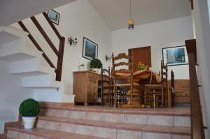 a living room with stairs and a table and chairs at Beach House Casa Erica in Ampurias