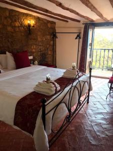a bedroom with a large bed with towels on it at La Posada de Leza Your wine country getaway in Laguardia