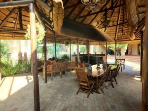 an outdoor dining area with tables and chairs at Goodnight Guest Lodge in Johannesburg