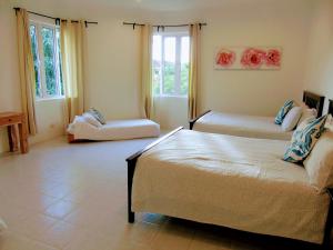 a bedroom with two beds in a room at Rumah Putih B&B near KLIA in Sepang