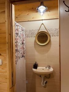 a bathroom with a sink and a mirror on the wall at Boutique Thomas בוטיק תומאס in Haifa +26 photos