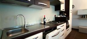 a kitchen with a sink and a counter top at Elly's house in Alessandria