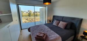 a bedroom with a large bed with a large window at The View - Porto - Apartment on TOP location with amazing view! in Vila Nova de Gaia