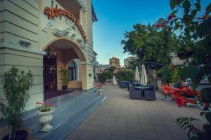 a balcony of a building with tables and chairs at Hotel Eden in Iaşi