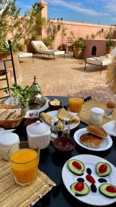 een tafel met borden eten erop bij Riad Dar Foundouk and Spa in Marrakesh