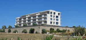 a white building on top of a stone wall at The View - Porto - Apartment on TOP location with amazing view! in Vila Nova de Gaia