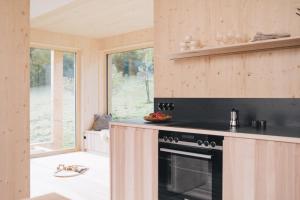 a kitchen with a stove top oven next to a window at Pinjola in Vandans