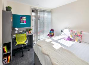 1 dormitorio con cama, escritorio y silla en The Crows Nest - UCC Summer Beds en Cork