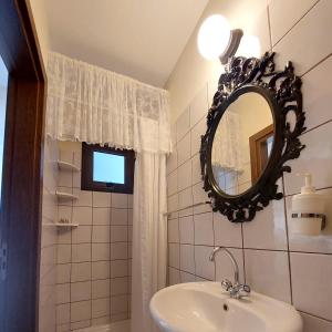 a bathroom with a sink and a mirror at Estia Vasilis Manoli in Ayia Napa