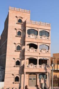 a tall building with a balcony on the side of it at Kailash Haveli in Bikaner