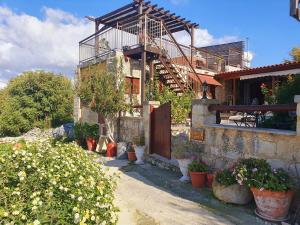 a house with a wooden door and some potted plants at HideAway Lasa in Lasa