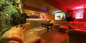 a living room with a couch and a bar at Afrodita Wellness Apartman Prague in Prague
