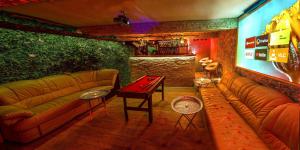 a living room with a couch and a table at Afrodita Wellness Apartman Prague in Prague