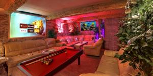 a living room with a pool table in a room at Afrodita Wellness Apartman Prague in Prague