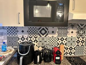 a kitchen with a counter top with a microwave at Studio moderne proche Disney Land in Bussy-Saint-Georges