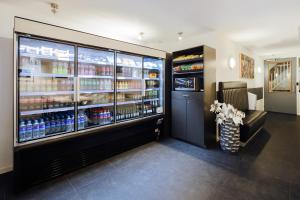 a store with a large refrigerator with drinks in it at Hotel CC in Amsterdam