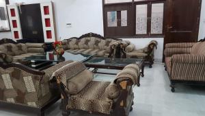 a living room with couches and a table at Kailash Haveli in Bikaner