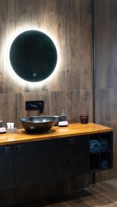 a bathroom with a bowl sink on a wooden counter at The Gums Anchorage in Bellara