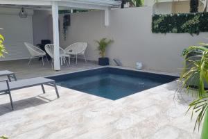 a swimming pool in the middle of a patio at Le Ti Bourgeois in Rivière-Salée