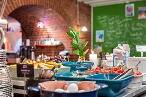 a buffet of food on a table in a restaurant at Best Western Tidbloms Hotel in Gothenburg