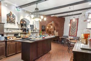 a large kitchen with a counter in a restaurant at Best Western Tidbloms Hotel in Gothenburg