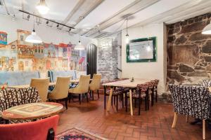 a restaurant with tables and chairs and a stone wall at Best Western Tidbloms Hotel in Gothenburg +39 photos