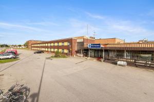 an empty parking lot in front of a building at Best Western Hotel Scheele in Köping