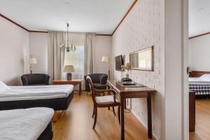 a hotel room with two beds and a desk at Best Western Hotel Scheele in Köping +48 photos