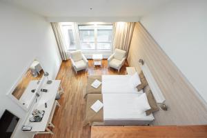 an overhead view of a living room with a couch and chairs at Hotel K5 Levi and K5 Villas in Levi