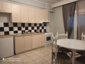 a kitchen with a table and a table and a dining room at Thess Rooms Agion Panton 12 in Thessaloniki