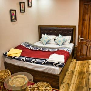 a bedroom with a bed in a room with a table at Traditional Hotel & Restaurant in Darjeeling