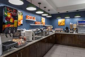 a fast food restaurant with a counter with a coffeeastery at Comfort Suites Natchitoches in Natchitoches