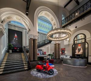 a lobby with a red scooter in the middle at Radisson RED Hotel, Liverpool in Liverpool