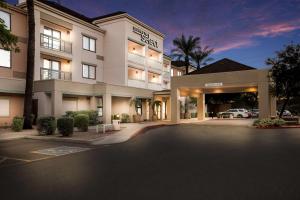 a hotel with a parking lot in front of it at Sonesta Select Phoenix Chandler in Chandler