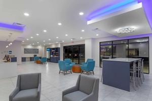a lobby with chairs and a bar in a building at Clarion Pointe Kimball in Kimball