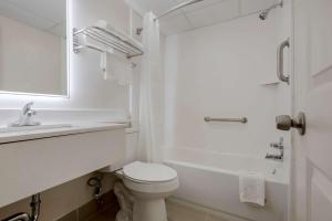 a white bathroom with a toilet and a sink at Quality Inn & Suites New Hartford - Utica in Utica +32 photos