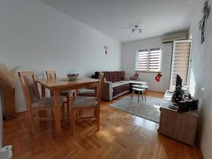 a living room with a table and a couch at Apartman Lena in Vrnjačka Banja