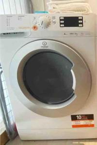 a white washing machine with a black door at New 1 bedroom in Kirchberg, Outdoor & Parking in Luxembourg